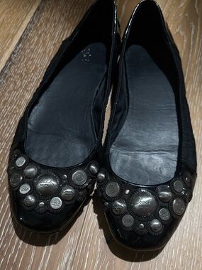 Coach Black Leather Ballet Flats with Silver Medallion Accents
